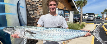 Young man with large mackerel.